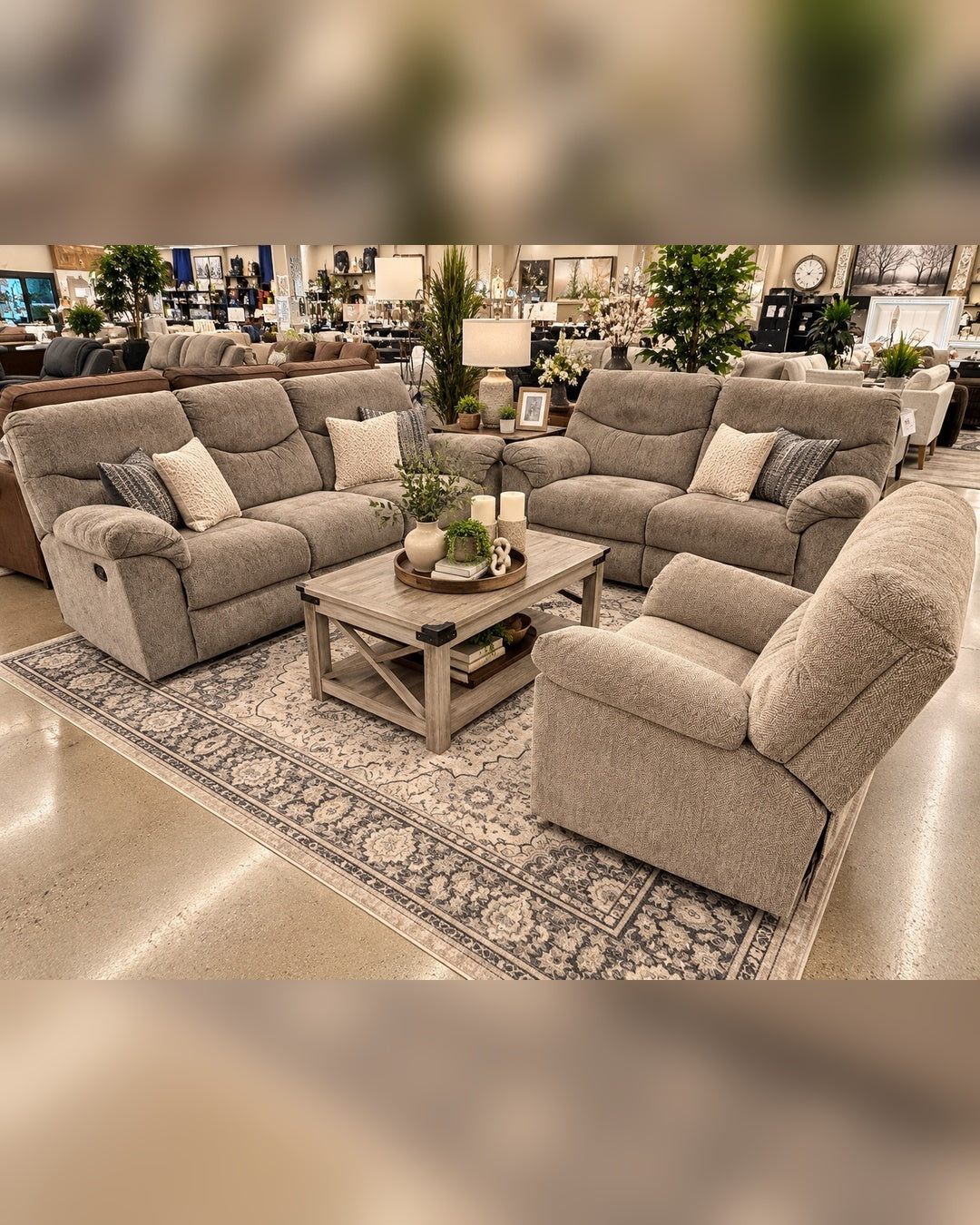 Reclining sofa, loveseat and recliner set in the showroom